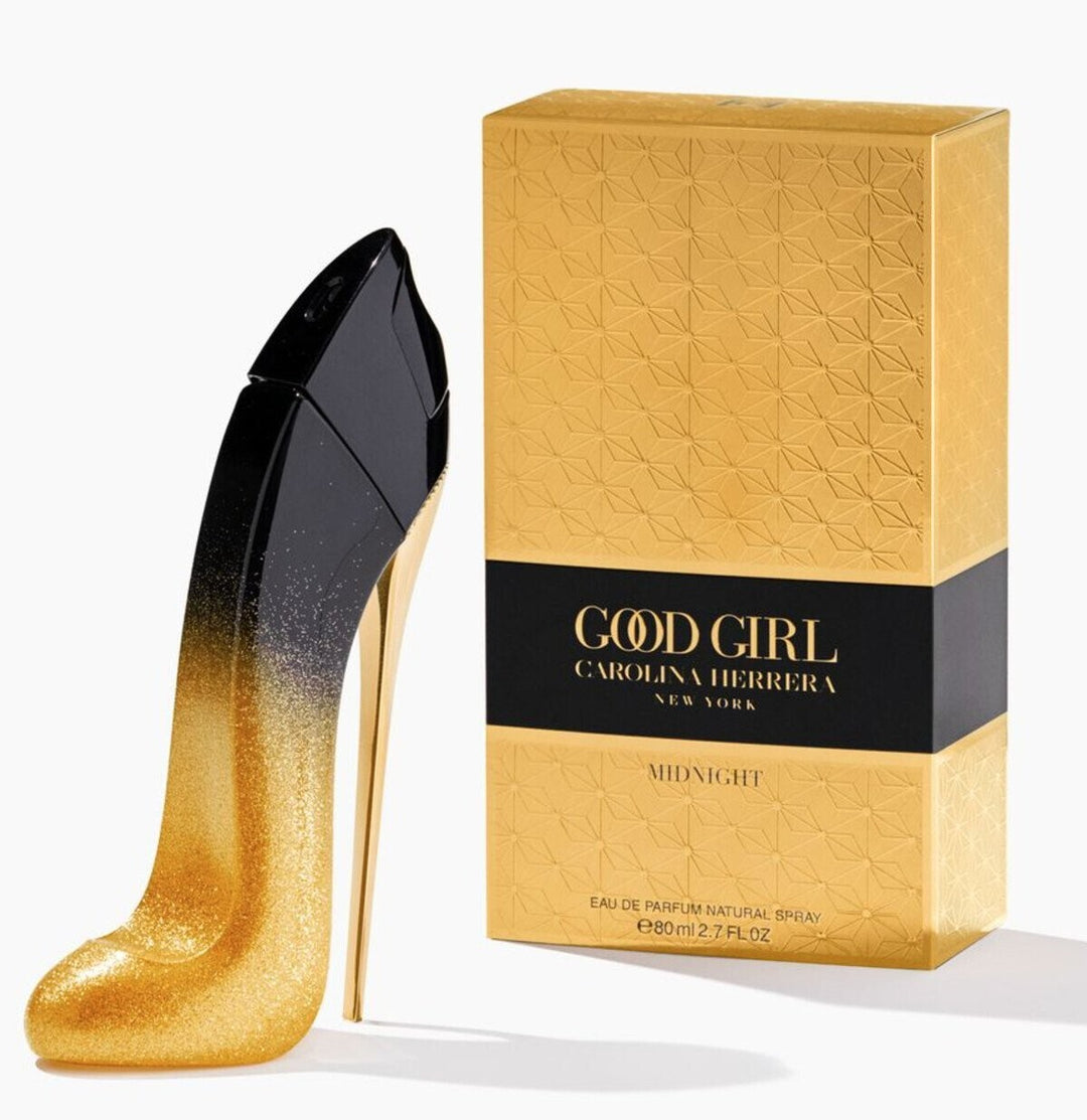 Gold high-heeled shoe and Carolina Herrera 'Good Girl' perfume box on a white background