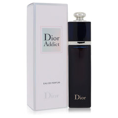 Dior Addict Eau de Parfum bottle in dark navy blue with a silver cap, standing next to its white and pale blue box on a white background.