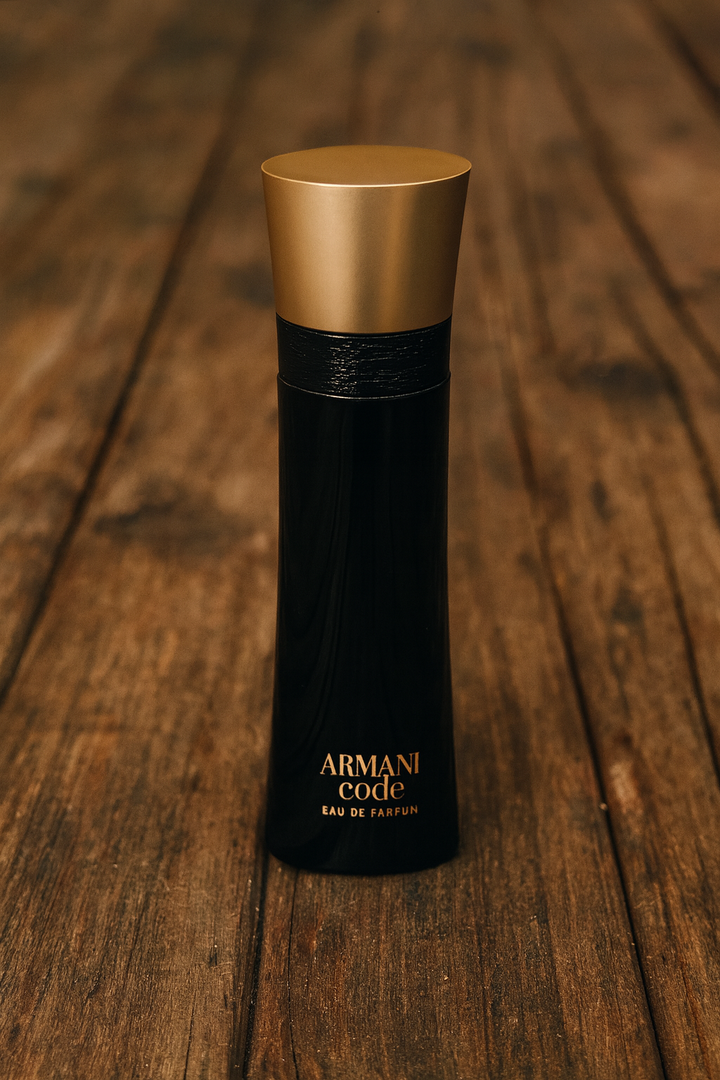 Black and gold Armani Code perfume bottle on a wooden surface