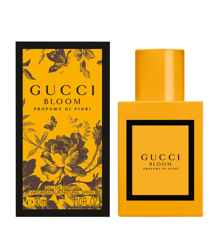 Gucci Bloom perfume bottle and packaging with yellow and black design.