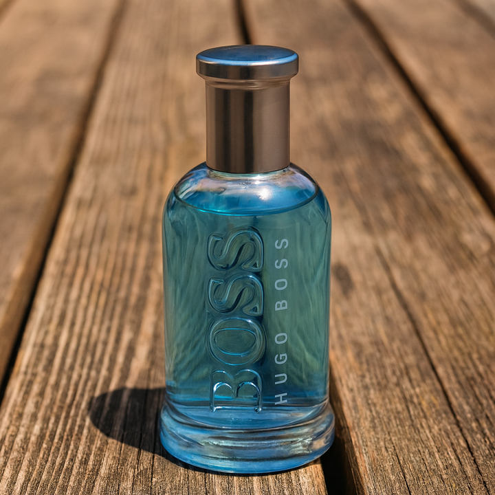 Blue Hugo Boss perfume bottle on a wooden surface