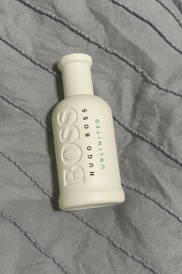 Hugo Boss Unlimited bottle on a textured gray surface