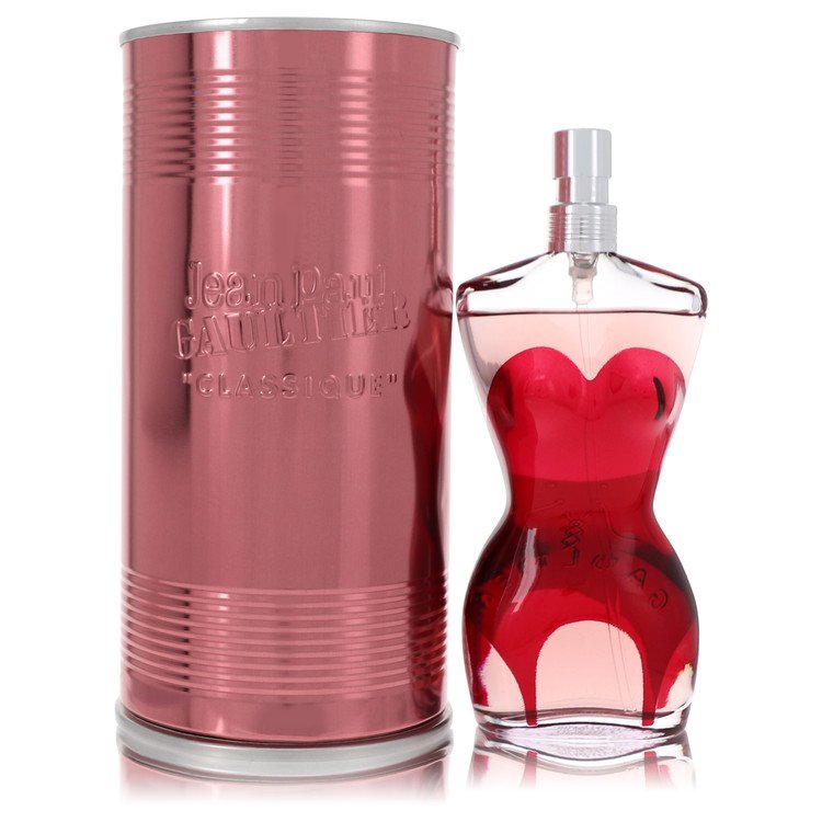 Red cylindrical container and red heart-shaped perfume bottle with 'Jean Paul Gaultier' branding on a white background.