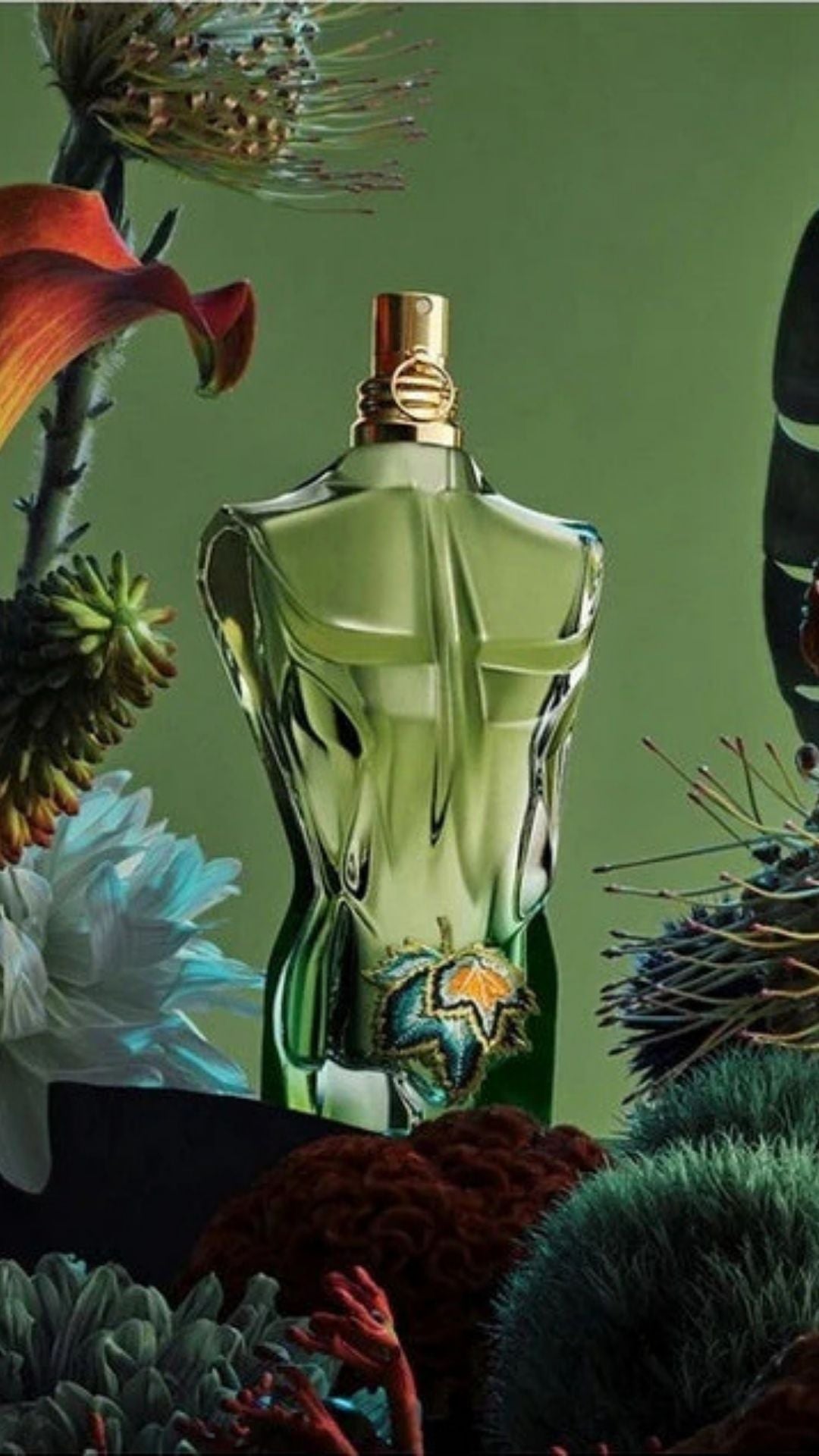 Perfume bottle with a green and gold design surrounded by flowers and plants on a green background