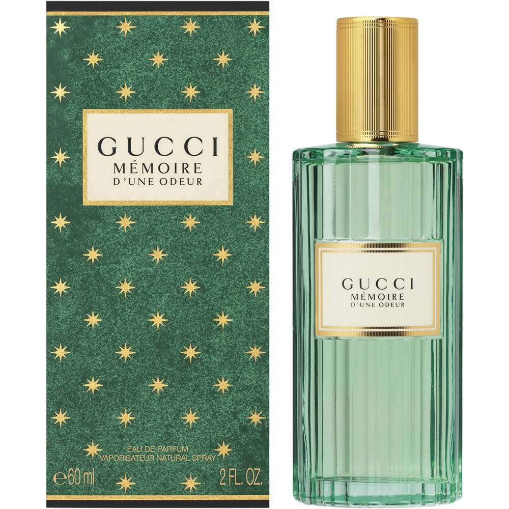 Gucci Memoire d'Une Odeur perfume bottle and packaging with gold stars on a green background