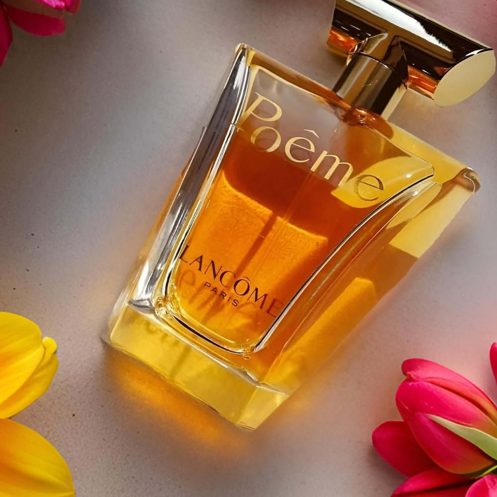 Lancome Poème perfume bottle with flowers on a light background