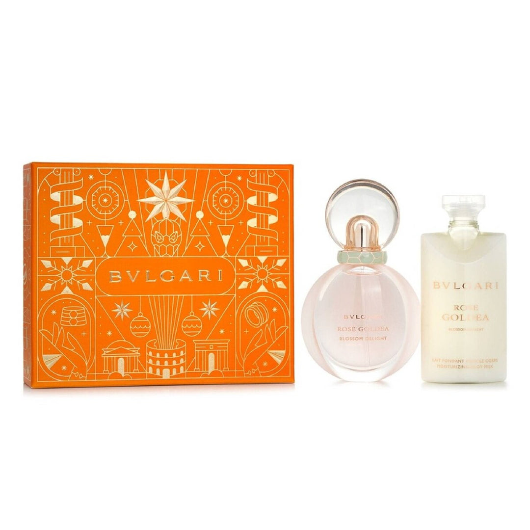 Bvlgari Acqua di Gioia Eau de Toilette set featuring an orange illustrated gift box, a pink glass perfume bottle, and a frosted white body spray bottle on a white background.