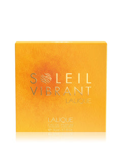 Lalique Soleil Vibrant Eau de Parfum box in a textured golden-yellow color with silver lettering, shown on a white background with a soft reflection.