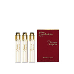 Three perfume bottles and their packaging on a white background
