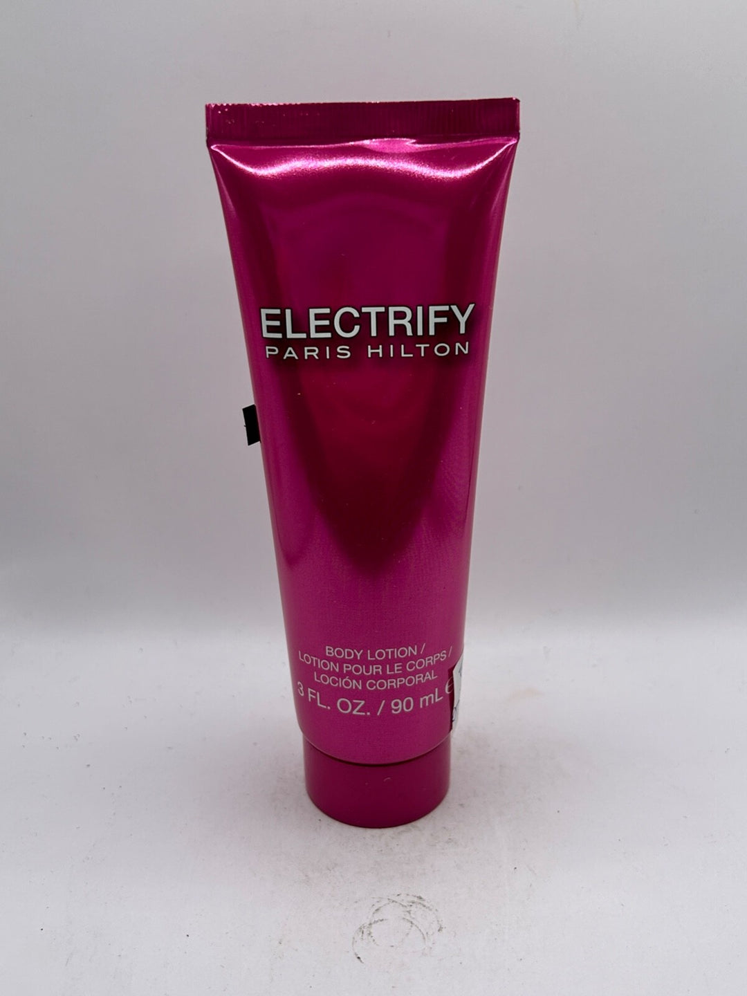 image showing the bottle and packaging for Paris Hilton Electrify Perfume By Paris Hilton Body Lotion 90ml
